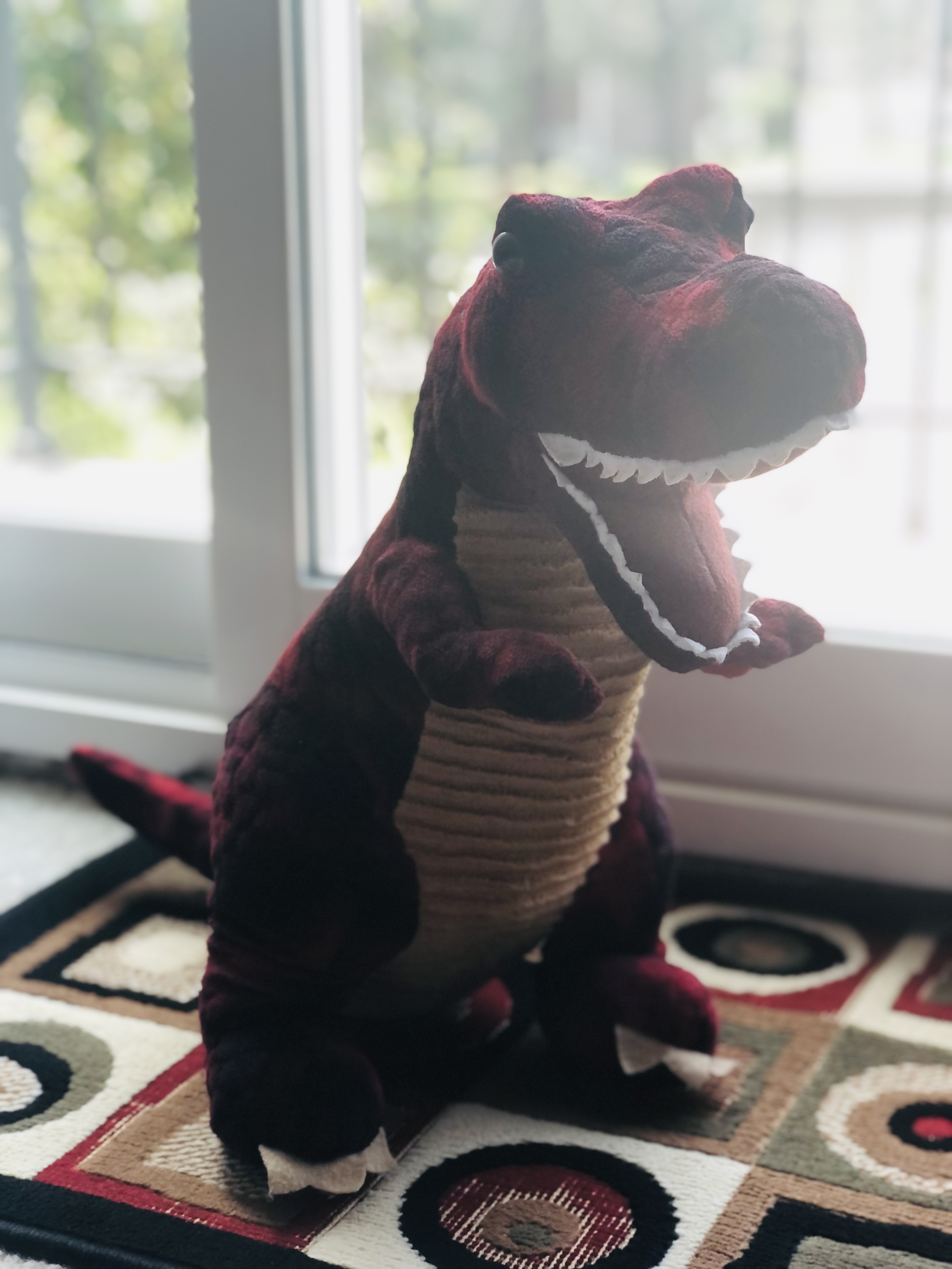 medium sized stuffed red t-rex